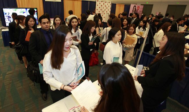 Banks in Koreatown are making an effort to understand today’s generation of millennials. One Korean-American millennials is submitting a resume at a job fair that was held last spring.